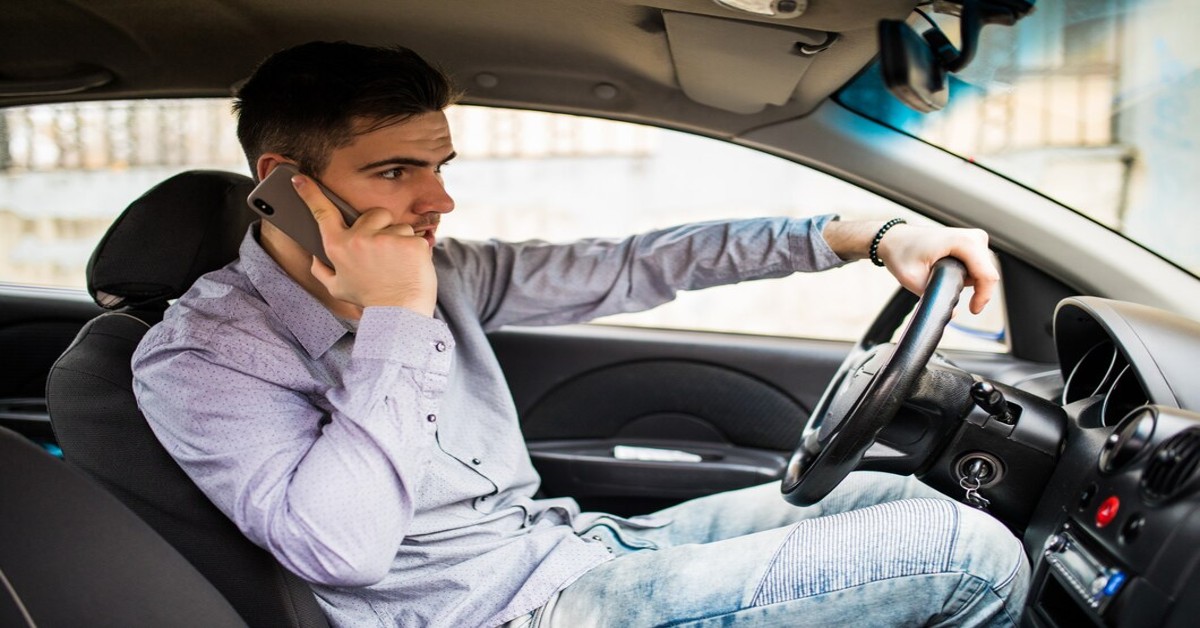 Man talking on phone while drive the car
